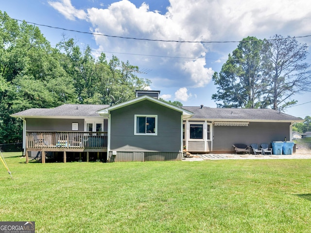 back of house featuring a yard and a wooden deck