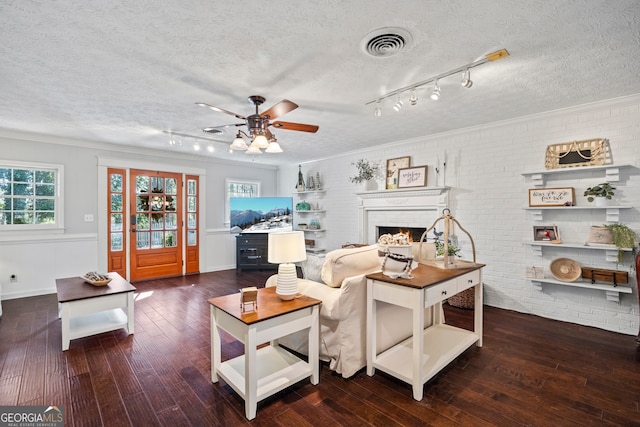 living room with ceiling fan, crown molding, and dark wood-type flooring