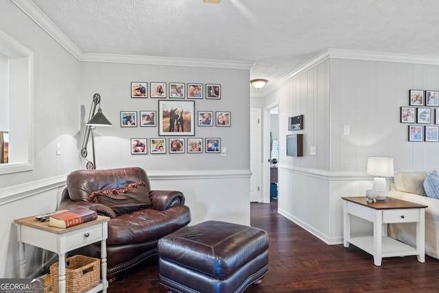 living room featuring dark hardwood / wood-style flooring, a textured ceiling, and ornamental molding