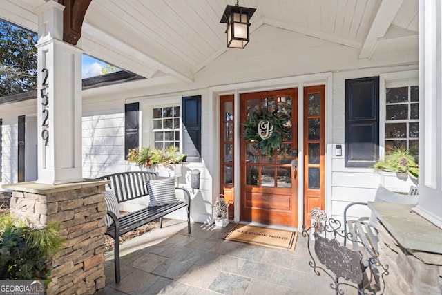 doorway to property featuring a porch