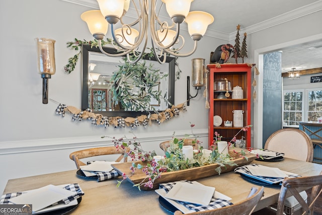 dining area featuring ornamental molding and a notable chandelier