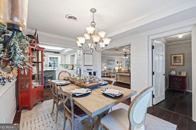 dining space featuring ceiling fan with notable chandelier, ornamental molding, and sink