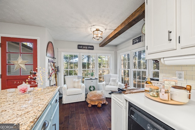 kitchen with white cabinets, decorative backsplash, beam ceiling, and a textured ceiling