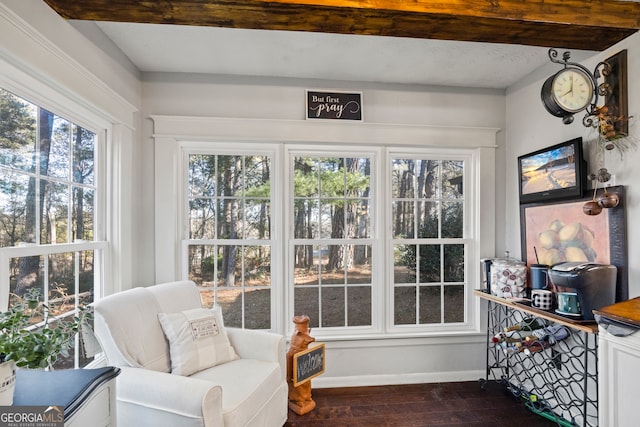 sunroom / solarium featuring beam ceiling