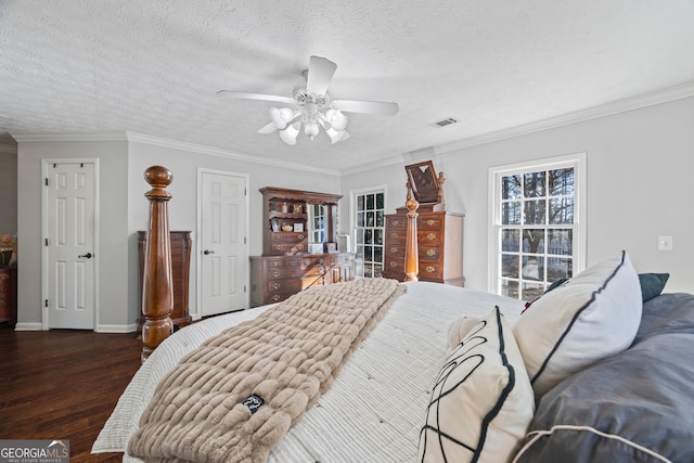 bedroom with a textured ceiling, ceiling fan, crown molding, and dark hardwood / wood-style floors