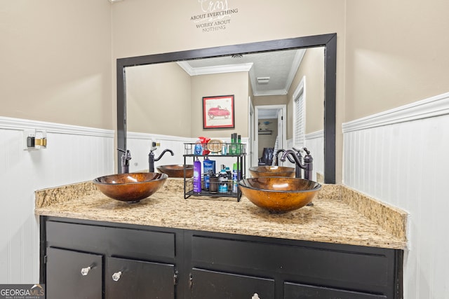 bathroom with vanity and crown molding