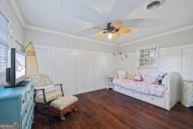 bedroom featuring dark hardwood / wood-style floors, ceiling fan, and crown molding