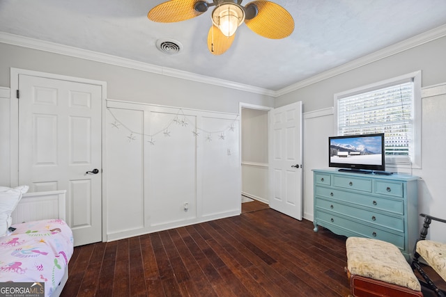 bedroom featuring dark hardwood / wood-style flooring, ceiling fan, and crown molding