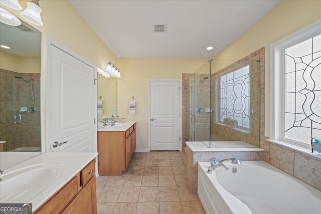 full bathroom with visible vents, a bath, two vanities, a shower stall, and a sink