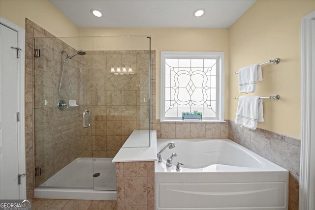 bathroom with a garden tub, a shower stall, and recessed lighting