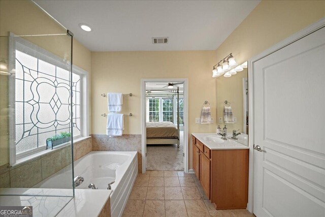 bathroom with vanity, tiled bath, tile patterned floors, and ceiling fan