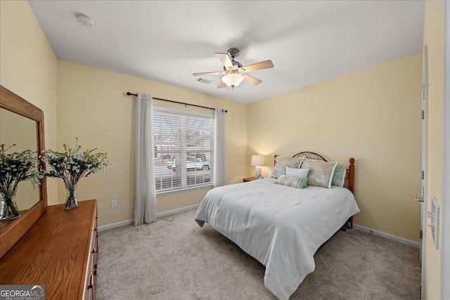 bedroom with a ceiling fan, carpet flooring, visible vents, and baseboards