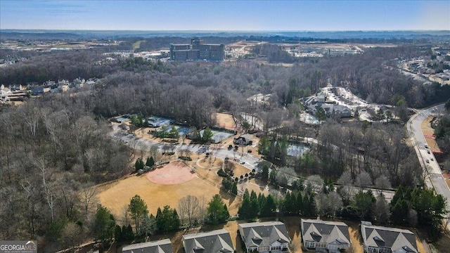 birds eye view of property with a view of trees