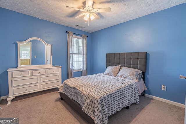 carpeted bedroom with a textured ceiling and ceiling fan