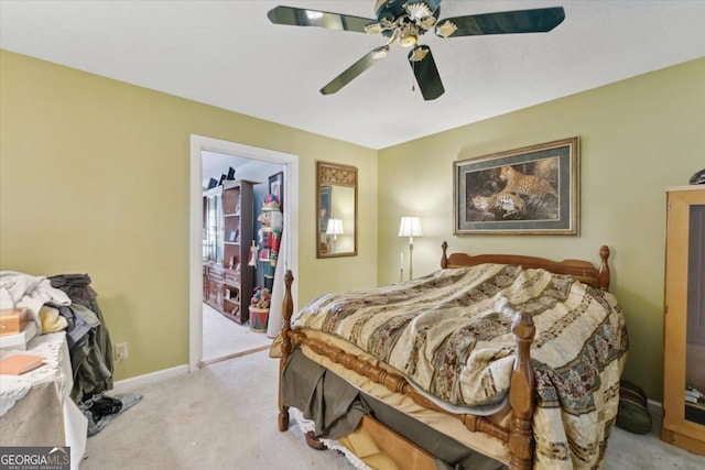 bedroom featuring light colored carpet and ceiling fan