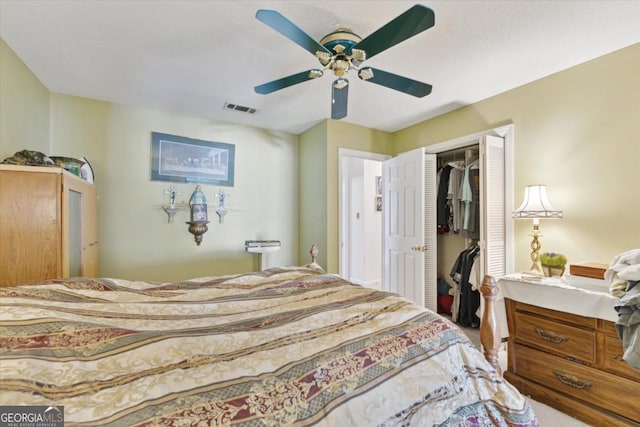 bedroom with ceiling fan and a closet