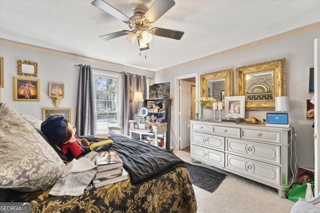 carpeted bedroom with a textured ceiling, ceiling fan, and crown molding