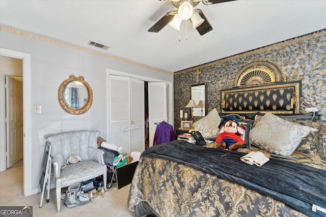 carpeted bedroom with ceiling fan and a closet