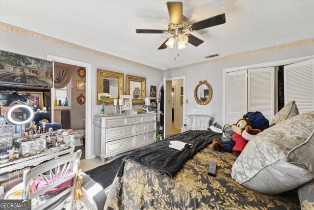 carpeted bedroom featuring ceiling fan, a closet, and ornamental molding