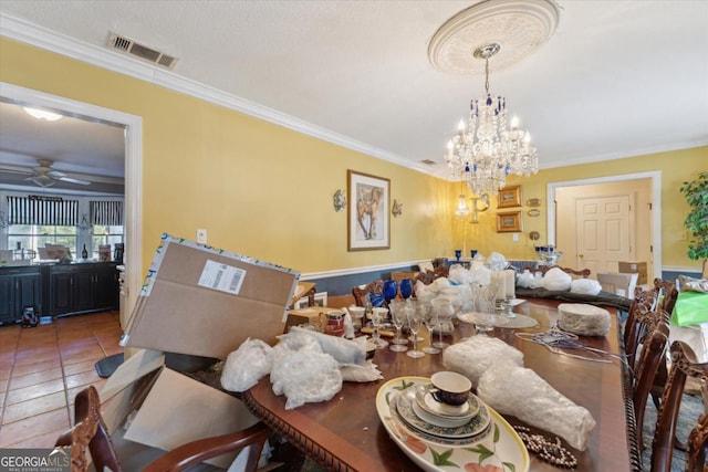 tiled dining space featuring ceiling fan with notable chandelier and ornamental molding