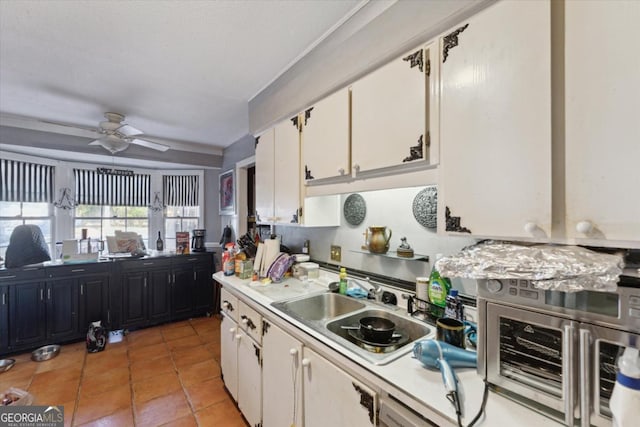 kitchen with white cabinetry, sink, ceiling fan, and light tile patterned floors