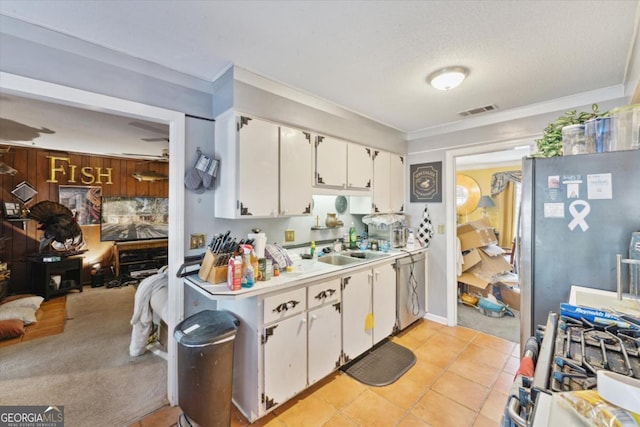 kitchen with sink, white cabinets, stainless steel appliances, and ornamental molding