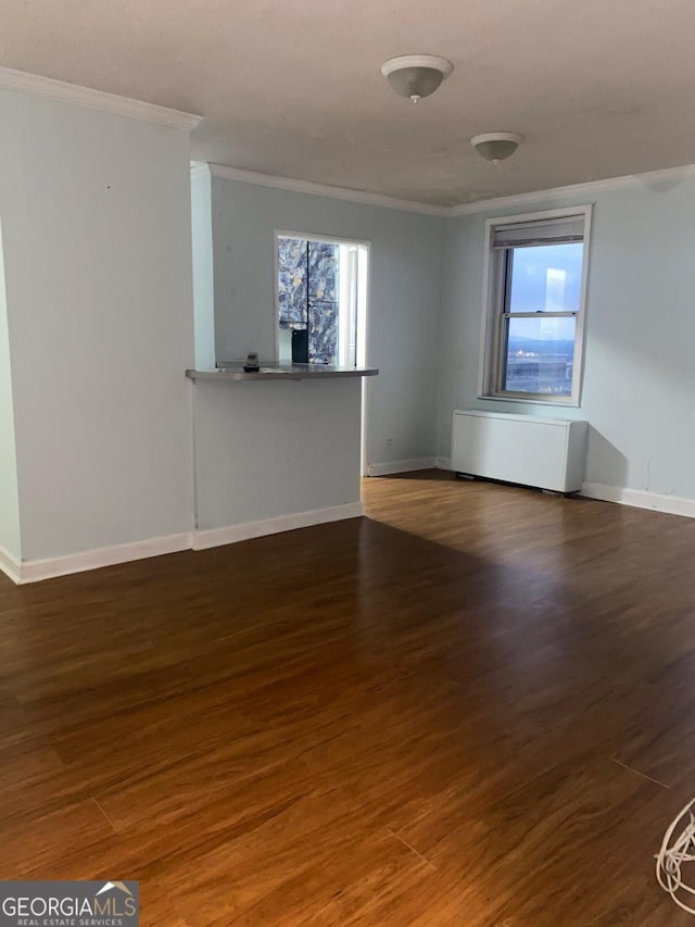 unfurnished living room featuring dark hardwood / wood-style floors and crown molding