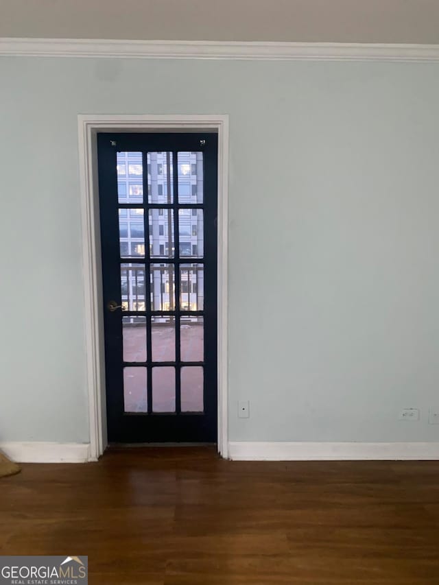 interior space featuring crown molding and dark hardwood / wood-style floors