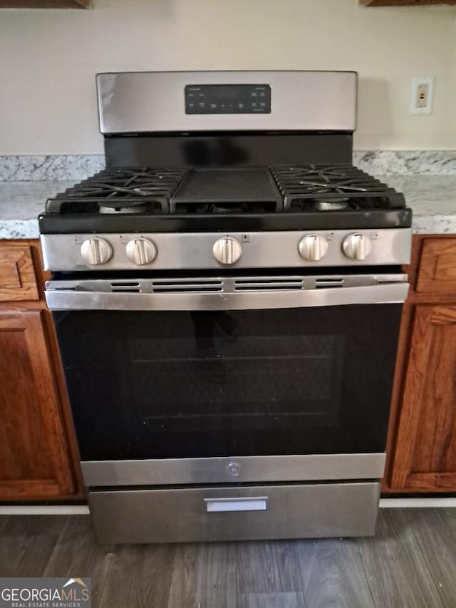 kitchen featuring gas range and dark wood-type flooring