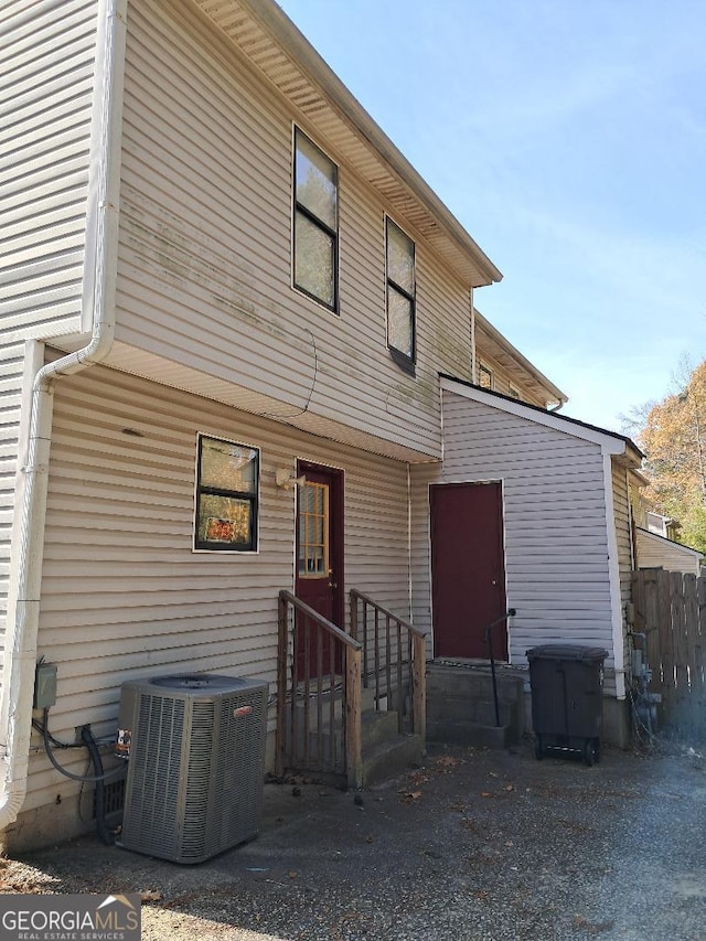 back of house featuring central AC unit