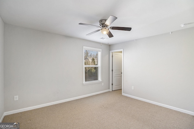 unfurnished room featuring light colored carpet and ceiling fan