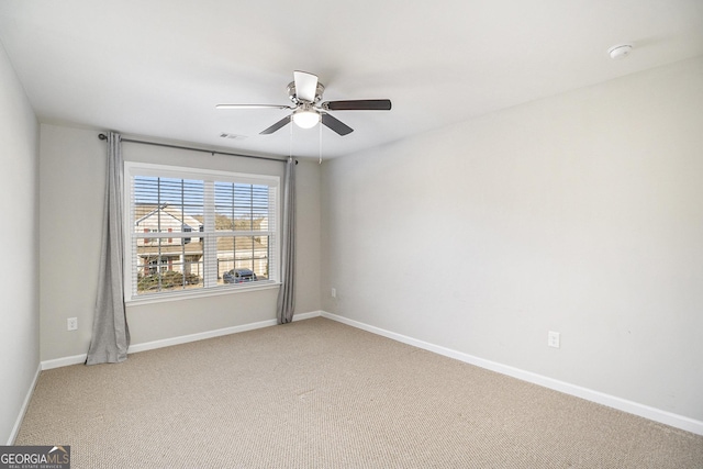 spare room featuring carpet floors and ceiling fan