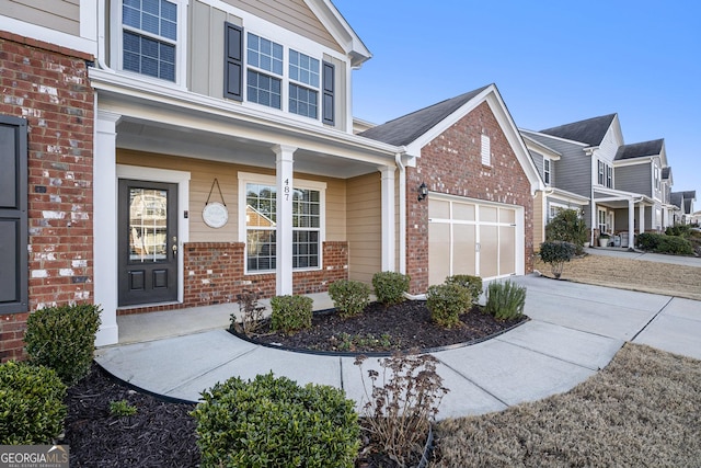 exterior space with a porch and a garage