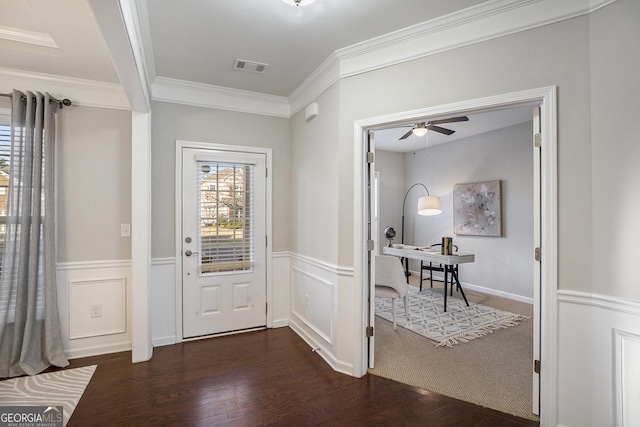 foyer with dark wood-type flooring, ornamental molding, and ceiling fan