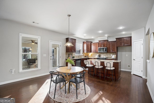 dining room featuring dark wood-type flooring and ceiling fan