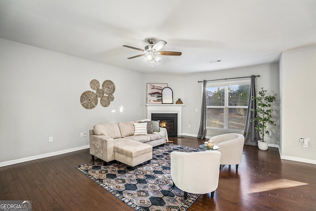 living room featuring dark hardwood / wood-style flooring and ceiling fan