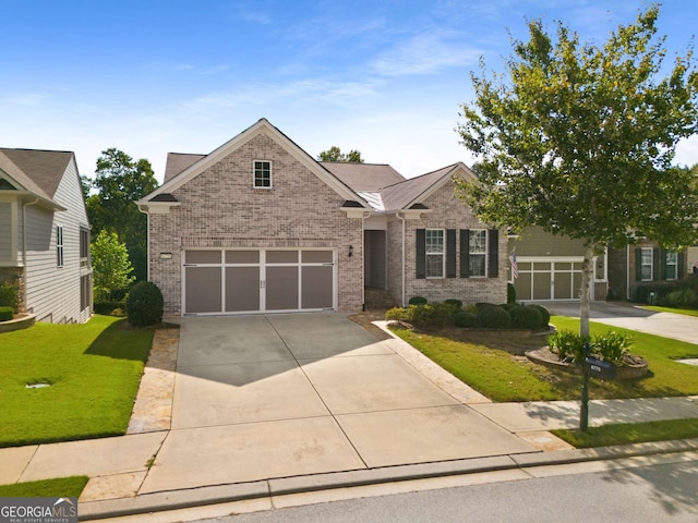 craftsman house with a front yard and a garage