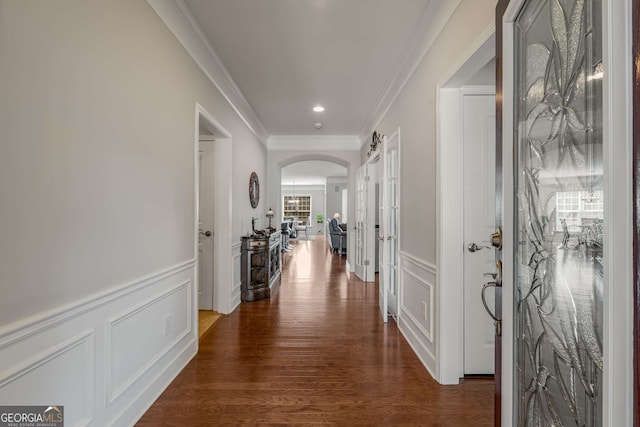 corridor with dark hardwood / wood-style floors and ornamental molding