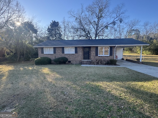 ranch-style house with a carport and a front lawn