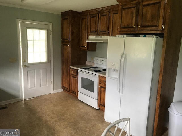 kitchen featuring dark brown cabinetry, white appliances, and crown molding