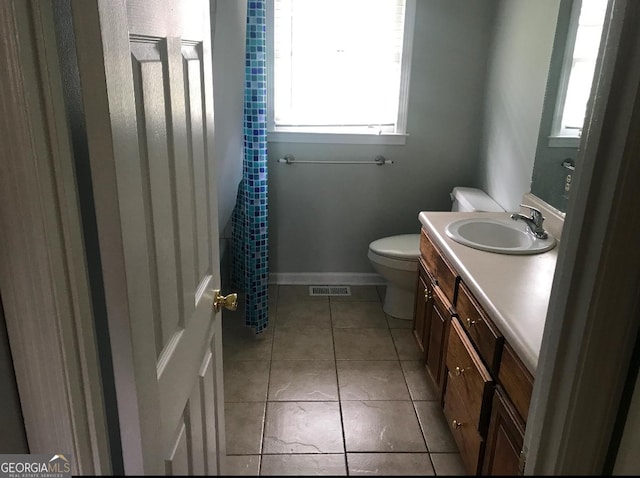 bathroom featuring tile patterned floors, vanity, and toilet