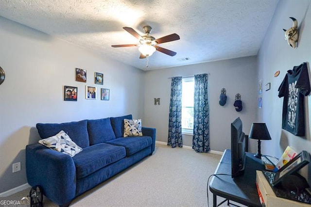 living room featuring a textured ceiling, light colored carpet, and ceiling fan