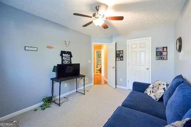 carpeted living room featuring a textured ceiling and ceiling fan