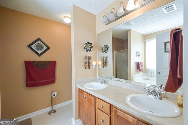 bathroom featuring tile patterned floors, vanity, and shower with separate bathtub