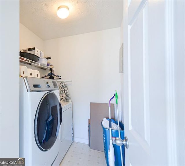 washroom featuring washer and dryer and a textured ceiling