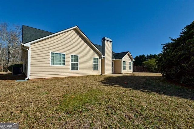 back of house with a lawn