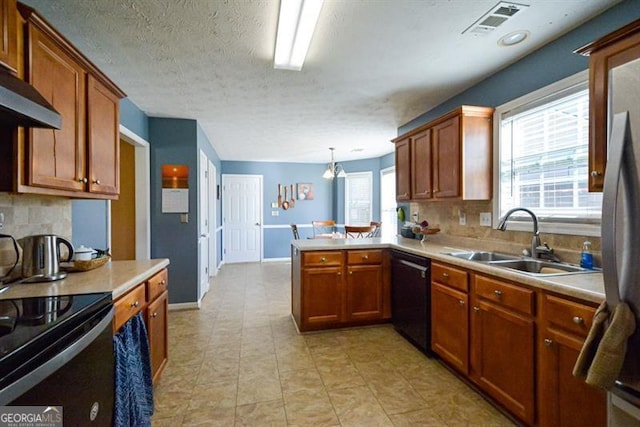 kitchen with kitchen peninsula, decorative backsplash, sink, black appliances, and pendant lighting