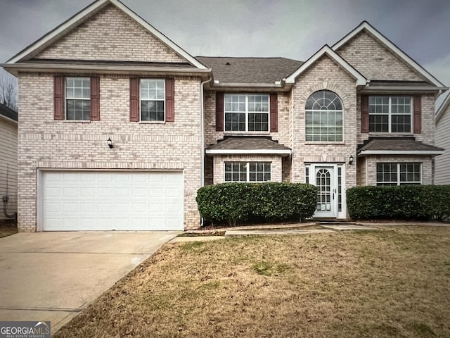 view of front of home featuring a front lawn and a garage