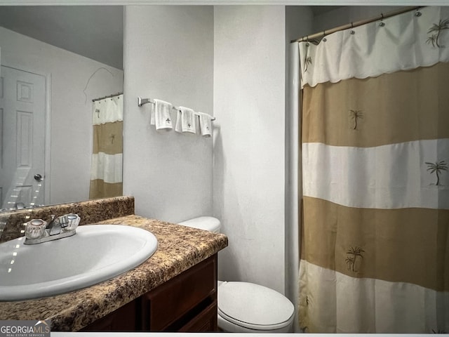 bathroom featuring vanity and toilet