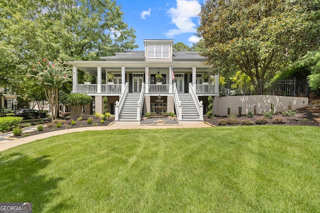 view of front of house with covered porch and a front lawn